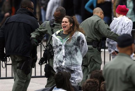An environmental activist sings and cheers as she and others are detained as they hold a rally in opposition to the Keystone XL Pipeline on An environmental activist sings and cheers as she and others are detained as they hold a rally in opposition to the Keystone XL Pipeline on