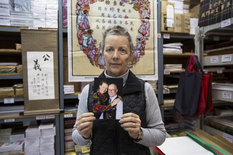 Karen Short, wife of Australian missionary John Short, poses with a photo of her husband inside the Christian Book Room in Hong Kong Februar Karen Short, wife of Australian missionary John Short, poses with a photo of her husband inside the Christian Book Room in Hong Kong Februar