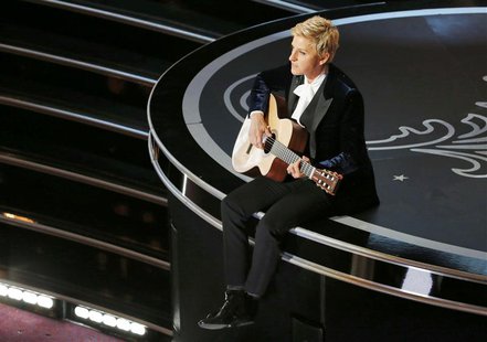 Host Ellen Degeneres plays a guitar at the 86th Academy Awards in Hollywood, California March 2, 2014. REUTERS/Lucy Nicholson Host Ellen Degeneres plays a guitar at the 86th Academy Awards in Hollywood, California March 2, 2014. REUTERS/Lucy Nicholson