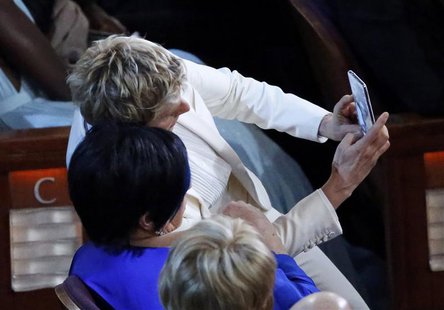 Host Ellen DeGeneres (top) takes a "selfie" photo with actress and singer Liza Minnelli at the 86th Academy Awards in Hollywood, California Host Ellen DeGeneres (top) takes a "selfie" photo with actress and singer Liza Minnelli at the 86th Academy Awards in Hollywood, California