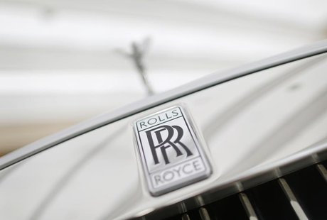 A Rolls-Royce mascot known as 'Spirit of Ecstasy' stands above the brand's logo on the front of a Rolls-Royce Ghost in a showroom in Singapo A Rolls-Royce mascot known as 'Spirit of Ecstasy' stands above the brand's logo on the front of a Rolls-Royce Ghost in a showroom in Singapo