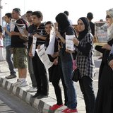 Demonstrators stand in silence on the second anniversary of the death of Egyptian Khaled Said as they carry his photo in front his house in Demonstrators stand in silence on the second anniversary of the death of Egyptian Khaled Said as they carry his photo in front his house in