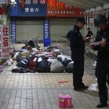 Policemen check unclaimed luggage at a square outside the Kunming railway station after a knife attack, in Kunming, Yunnan province March 2, Policemen check unclaimed luggage at a square outside the Kunming railway station after a knife attack, in Kunming, Yunnan province March 2,