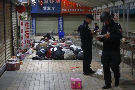 Policemen check unclaimed luggage at a square outside the Kunming railway station after a knife attack, in Kunming, Yunnan province March 2, Policemen check unclaimed luggage at a square outside the Kunming railway station after a knife attack, in Kunming, Yunnan province March 2,