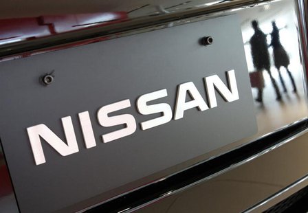 Visitors are reflected in a Nissan Motors' vehicle at the company's global headquarters in Yokohama, south of Tokyo March 30, 2010. REUTERS/ Visitors are reflected in a Nissan Motors' vehicle at the company's global headquarters in Yokohama, south of Tokyo March 30, 2010. REUTERS/