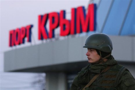 An armed man, believed to be a Russian soldier, stands outside the civilian port in the Crimean town of Kerch March 3, 2014. REUTERS/Thomas An armed man, believed to be a Russian soldier, stands outside the civilian port in the Crimean town of Kerch March 3, 2014. REUTERS/Thomas