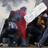 Anti-government protesters shield themselves from tear gas during a rally in Caracas March 2, 2014. REUTERS/Jorge Silva Anti-government protesters shield themselves from tear gas during a rally in Caracas March 2, 2014. REUTERS/Jorge Silva