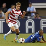 Stuart Holden (L) of the U.S. moves the ball away from Honduras' Alexander Lopez during their CONCACAF Gold Cup soccer match in Arlington, T Stuart Holden (L) of the U.S. moves the ball away from Honduras' Alexander Lopez during their CONCACAF Gold Cup soccer match in Arlington, T
