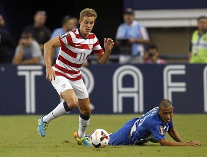 Stuart Holden (L) of the U.S. moves the ball away from Honduras' Alexander Lopez during their CONCACAF Gold Cup soccer match in Arlington, T Stuart Holden (L) of the U.S. moves the ball away from Honduras' Alexander Lopez during their CONCACAF Gold Cup soccer match in Arlington, T
