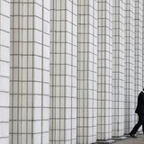 A man walks out from a business building in Tokyo January 24, 2013. REUTERS/Toru Hanai A man walks out from a business building in Tokyo January 24, 2013. REUTERS/Toru Hanai