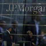 Workers are reflected in the windows of the Canary Wharf offices of JP Morgan in London September 19, 2013. REUTERS/Neil Hall Workers are reflected in the windows of the Canary Wharf offices of JP Morgan in London September 19, 2013. REUTERS/Neil Hall