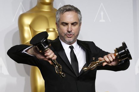 Alfonso Cuaron poses with the awards for best director and best film editing for "Gravity" at the 86th Academy Awards in Hollywood, Californ Alfonso Cuaron poses with the awards for best director and best film editing for "Gravity" at the 86th Academy Awards in Hollywood, Californ