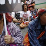 A group of anti-government protesters and some farmers sit on the main road outside the headquarters of the Royal Thai Police in central Ban A group of anti-government protesters and some farmers sit on the main road outside the headquarters of the Royal Thai Police in central Ban