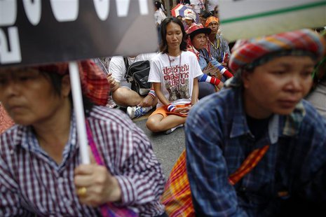A group of anti-government protesters and some farmers sit on the main road outside the headquarters of the Royal Thai Police in central Ban A group of anti-government protesters and some farmers sit on the main road outside the headquarters of the Royal Thai Police in central Ban