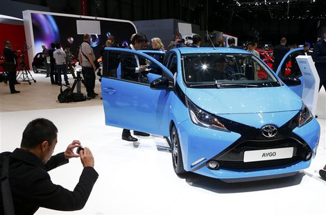 A visitor takes pictures of Toyota Aygo during the media day ahead of the 84th Geneva Motor Show at the Palexpo Arena in Geneva March 4, 201 A visitor takes pictures of Toyota Aygo during the media day ahead of the 84th Geneva Motor Show at the Palexpo Arena in Geneva March 4, 201