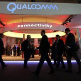 Visitors walk past the Qualcomm stand at the Mobile World Congress in Barcelona, February 24, 2014. REUTERS/Albert Gea Visitors walk past the Qualcomm stand at the Mobile World Congress in Barcelona, February 24, 2014. REUTERS/Albert Gea