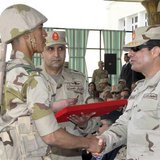 Egypt's army chief Field Marshal Abdel Fattah al-Sisi (R) shakes hands with a military cadet at the end of a ceremony to mark the end of the Egypt's army chief Field Marshal Abdel Fattah al-Sisi (R) shakes hands with a military cadet at the end of a ceremony to mark the end of the