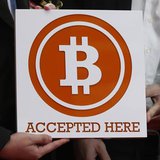 A bitcoin sign is held outside Hong Kong's first bitcoin retail store during its opening, in Hong Kong February 28, 2014. REUTERS/Bobby Yip A bitcoin sign is held outside Hong Kong's first bitcoin retail store during its opening, in Hong Kong February 28, 2014. REUTERS/Bobby Yip