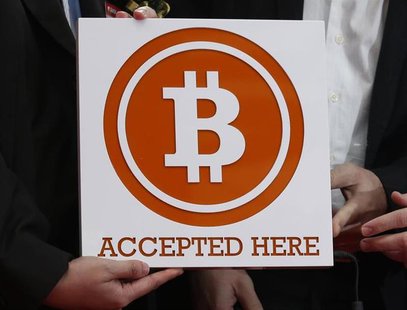 A bitcoin sign is held outside Hong Kong's first bitcoin retail store during its opening, in Hong Kong February 28, 2014. REUTERS/Bobby Yip A bitcoin sign is held outside Hong Kong's first bitcoin retail store during its opening, in Hong Kong February 28, 2014. REUTERS/Bobby Yip