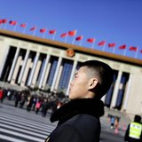 A soldier in plain clothes from the Chinese People's Liberation Army (PLA) stands guard in front of the Great Hall of the People, the venue A soldier in plain clothes from the Chinese People's Liberation Army (PLA) stands guard in front of the Great Hall of the People, the venue
