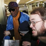 Bodyguards clear a path for former NBA basketball player Dennis Rodman (C) as journalists surround him upon his arrival from North Korea's P Bodyguards clear a path for former NBA basketball player Dennis Rodman (C) as journalists surround him upon his arrival from North Korea's P