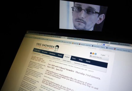A portrait of former U.S. spy agency contractor Edward Snowden is displayed behind a screen as he answers users' questions on Twitter in thi A portrait of former U.S. spy agency contractor Edward Snowden is displayed behind a screen as he answers users' questions on Twitter in thi