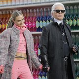 German designer Karl Lagerfeld (R) and model Cara Delevingne appear at the end of his Fall/Winter 2014-2015 women's ready-to-wear collection German designer Karl Lagerfeld (R) and model Cara Delevingne appear at the end of his Fall/Winter 2014-2015 women's ready-to-wear collection