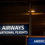 US Airways and American Airlines signs are pictured at Philadelphia International Airport in Philadelphia, Pennsylvania on December 9, 2013. US Airways and American Airlines signs are pictured at Philadelphia International Airport in Philadelphia, Pennsylvania on December 9, 2013.