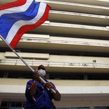 An anti-government protester waves a Thai national flag during a rally at the Department of Public Works and Town & Country Planning in Bang An anti-government protester waves a Thai national flag during a rally at the Department of Public Works and Town & Country Planning in Bang