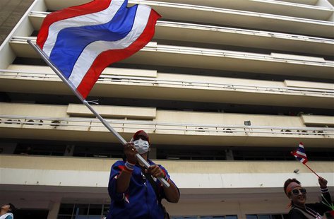 An anti-government protester waves a Thai national flag during a rally at the Department of Public Works and Town & Country Planning in Bang An anti-government protester waves a Thai national flag during a rally at the Department of Public Works and Town & Country Planning in Bang