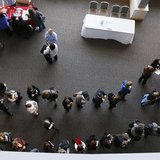 Hundreds of job seekers wait in line with their resumes to talk to recruiters (right) at the Colorado Hospital Association health care caree Hundreds of job seekers wait in line with their resumes to talk to recruiters (right) at the Colorado Hospital Association health care caree