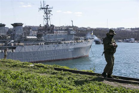 A Russian soldier stands guard near Ukrainian navy command ship Slavutych at the Crimean port of Sevastopol March 5, 2014. REUTERS/Baz Ratne A Russian soldier stands guard near Ukrainian navy command ship Slavutych at the Crimean port of Sevastopol March 5, 2014. REUTERS/Baz Ratne