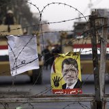 A poster of ousted Egyptian President Mohamed Mursi is pictured on barbed wires during a protest by his supporters at El-Thadiya presidentia A poster of ousted Egyptian President Mohamed Mursi is pictured on barbed wires during a protest by his supporters at El-Thadiya presidentia