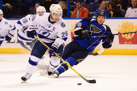 Mar 4, 2014; St. Louis, MO, USA; Tampa Bay Lightning right wing Martin St. Louis (26) skates with the puck against the St. Louis Blues durin Mar 4, 2014; St. Louis, MO, USA; Tampa Bay Lightning right wing Martin St. Louis (26) skates with the puck against the St. Louis Blues durin