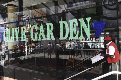 A man talks on his mobile phone in front of the Times Square Olive Garden in New York, June 23, 2010. REUTERS/Keith Bedford A man talks on his mobile phone in front of the Times Square Olive Garden in New York, June 23, 2010. REUTERS/Keith Bedford
