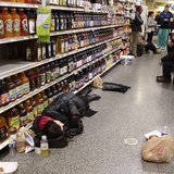 People rest at the aisle of a Publix grocery store after being stranded due to a snow storm in Atlanta, Georgia, January 29, 2014. REUTERS/T People rest at the aisle of a Publix grocery store after being stranded due to a snow storm in Atlanta, Georgia, January 29, 2014. REUTERS/T