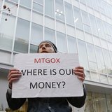 Kolin Burges, a self-styled cryptocurrency trader and former software engineer who came from London, holds a placard to protest against Mt. Kolin Burges, a self-styled cryptocurrency trader and former software engineer who came from London, holds a placard to protest against Mt.