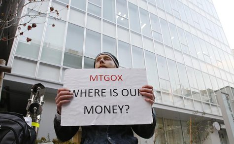 Kolin Burges, a self-styled cryptocurrency trader and former software engineer who came from London, holds a placard to protest against Mt. Kolin Burges, a self-styled cryptocurrency trader and former software engineer who came from London, holds a placard to protest against Mt.