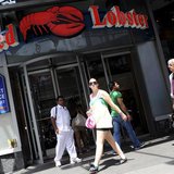 Passersby walk in front of the Times Square Red Lobster restaurant in New York, June 23, 2010. REUTERS/Keith Bedford Passersby walk in front of the Times Square Red Lobster restaurant in New York, June 23, 2010. REUTERS/Keith Bedford
