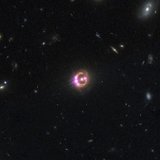 Multiple images of a distant quasar are visible in this undated combined view from NASA’s Chandra X-ray Observatory and the Hubble Space Tel Multiple images of a distant quasar are visible in this undated combined view from NASA’s Chandra X-ray Observatory and the Hubble Space Tel