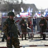 An armed man, believed to be a Russian soldier, stands guard inside a Ukrainian military base in the Crimean town of Yevpatoria, March 5, 20 An armed man, believed to be a Russian soldier, stands guard inside a Ukrainian military base in the Crimean town of Yevpatoria, March 5, 20