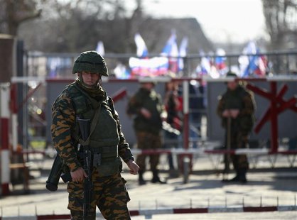 An armed man, believed to be a Russian soldier, stands guard inside a Ukrainian military base in the Crimean town of Yevpatoria, March 5, 20 An armed man, believed to be a Russian soldier, stands guard inside a Ukrainian military base in the Crimean town of Yevpatoria, March 5, 20