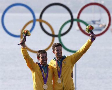 Australia's Mathew Belcher and Malcolm Page pose with their gold medals for the men's 470 sailing class at the London 2012 Olympic Games in Australia's Mathew Belcher and Malcolm Page pose with their gold medals for the men's 470 sailing class at the London 2012 Olympic Games in