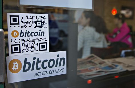 Signs on window advertise a bitcoin ATM machine that has been installed in a Waves Coffee House in Vancouver, British Columbia October 28, 2 Signs on window advertise a bitcoin ATM machine that has been installed in a Waves Coffee House in Vancouver, British Columbia October 28, 2