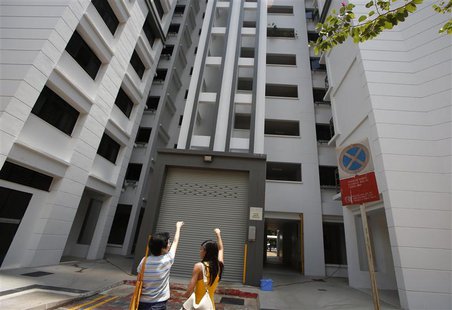 A resident (L) shows where she said the body of Autumn Radkte, chief executive of First Meta Pte Ltd, was found on the second floor of a pub A resident (L) shows where she said the body of Autumn Radkte, chief executive of First Meta Pte Ltd, was found on the second floor of a pub