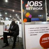 A job-seeker completes an application at a career fair held by civil rights organization National Urban League as part of its annual confere A job-seeker completes an application at a career fair held by civil rights organization National Urban League as part of its annual confere