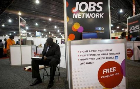 A job-seeker completes an application at a career fair held by civil rights organization National Urban League as part of its annual confere A job-seeker completes an application at a career fair held by civil rights organization National Urban League as part of its annual confere