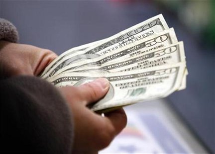 A customer counts her money at the register of a Toys R Us store on the Thanksgiving Day holiday in Manchester, New Hampshire November 22, 2 A customer counts her money at the register of a Toys R Us store on the Thanksgiving Day holiday in Manchester, New Hampshire November 22, 2