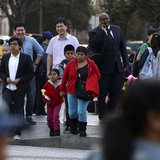 People stand at an intersection in Koreatown, one of several neighborhoods designated by the Obama administration as a "Promise Zone" in Los People stand at an intersection in Koreatown, one of several neighborhoods designated by the Obama administration as a "Promise Zone" in Los