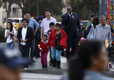 People stand at an intersection in Koreatown, one of several neighborhoods designated by the Obama administration as a "Promise Zone" in Los People stand at an intersection in Koreatown, one of several neighborhoods designated by the Obama administration as a "Promise Zone" in Los